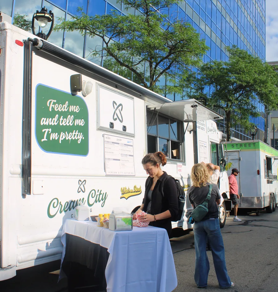 The side of the truck with its Feed me and tell me I am pretty panel and the service table set up beside it